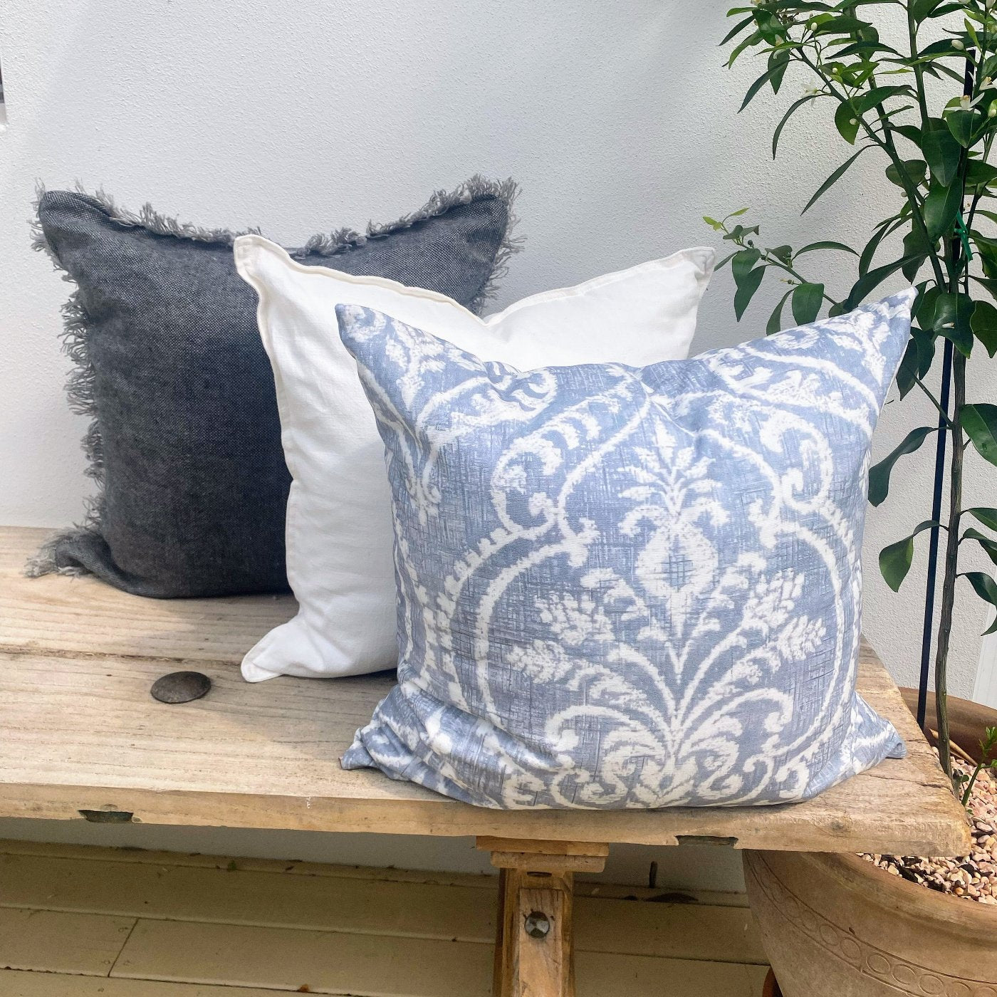 Set of 3 Grey and White Cushion Covers on an Elm Wood Bench Seat