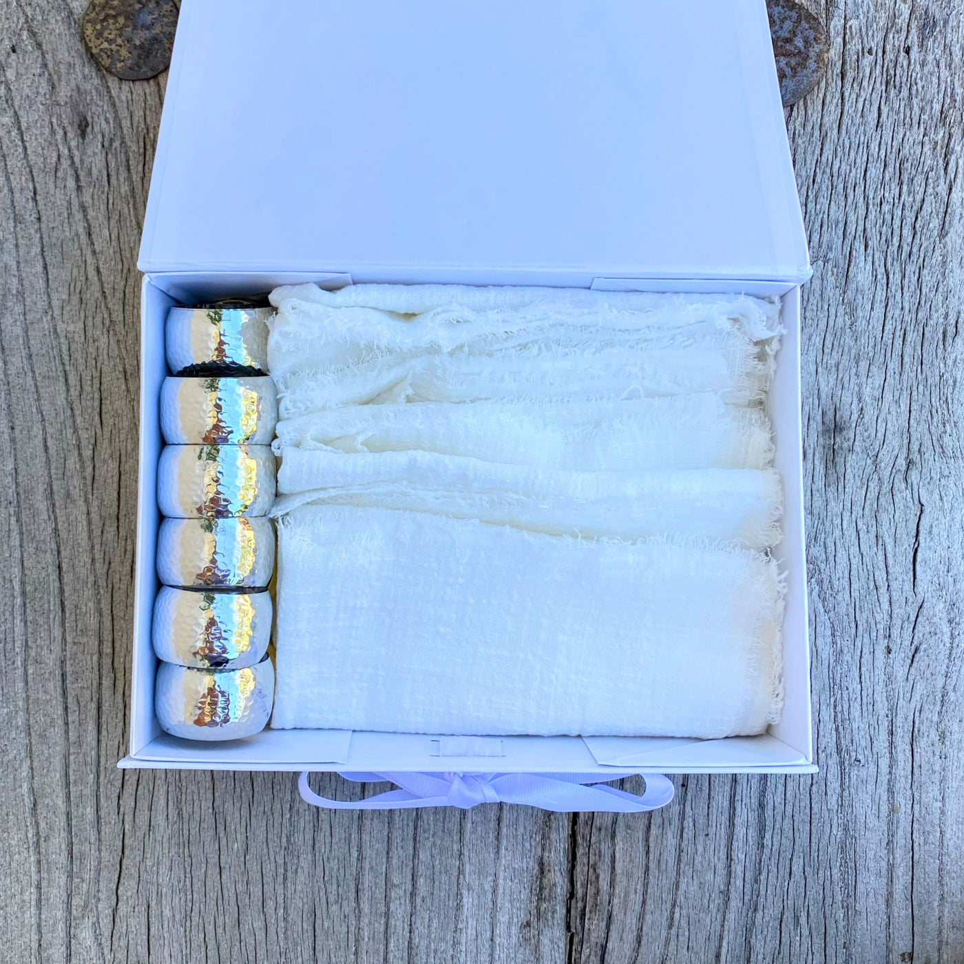 A Box of White Cotton Napkins with Silver Rings